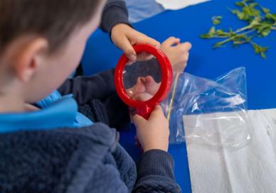 student using magnifying glass