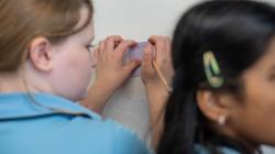 Students drawing on whiteboard